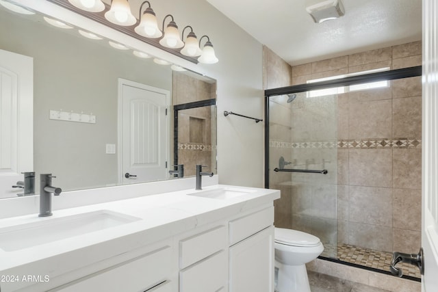 bathroom with tile patterned flooring, a textured ceiling, an enclosed shower, toilet, and vanity