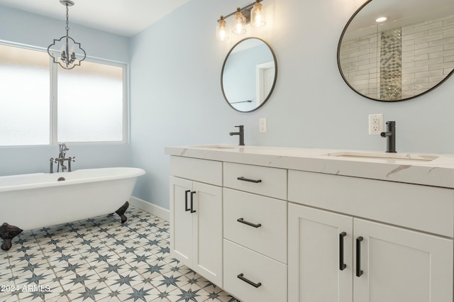 bathroom featuring a notable chandelier, a tub, and vanity