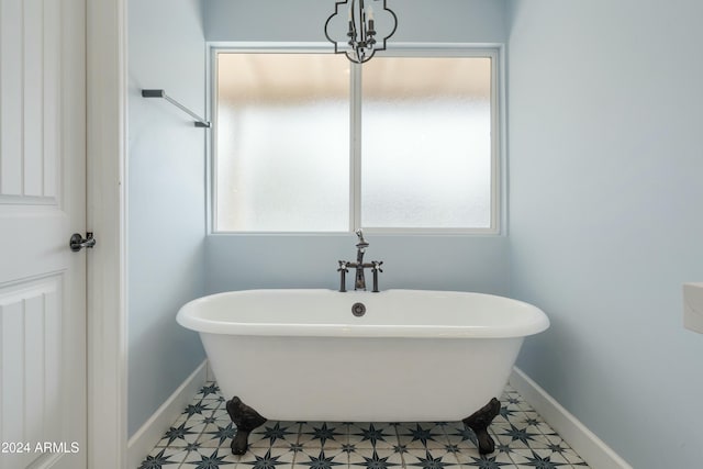 bathroom with tile patterned floors and a tub