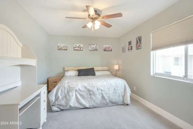 bedroom with light carpet and ceiling fan