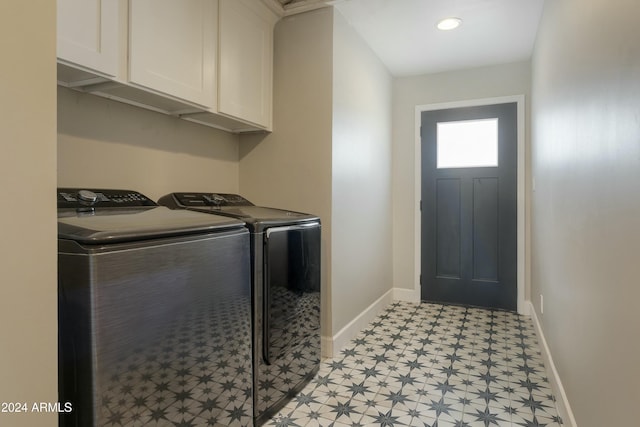 laundry area with washer and dryer and cabinets