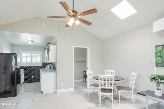 tiled dining area with tile walls, ceiling fan, sink, and lofted ceiling