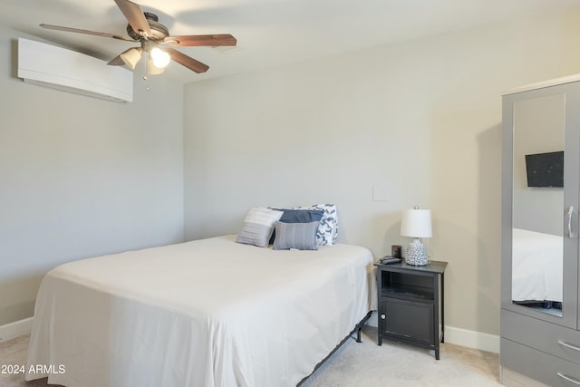 bedroom with a wall unit AC, ceiling fan, and light carpet