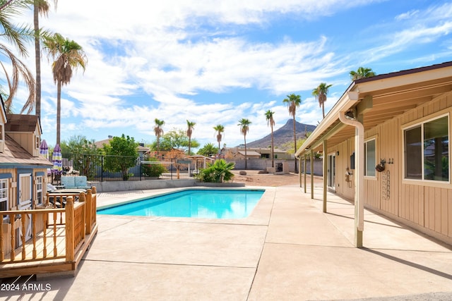 view of pool with a mountain view and a patio