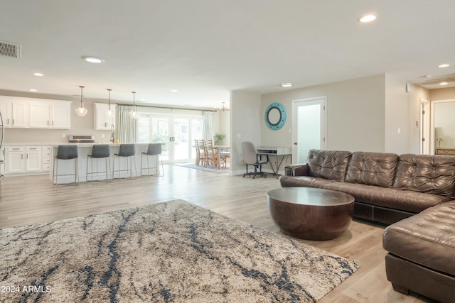 living room with french doors and light wood-type flooring