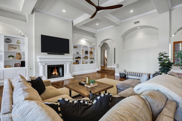2527 E Beechnut Ct, Chandler, AZ 85249 - living area featuring a ceiling fan, beam ceiling, wood finished floors, built in shelves, and a warm lit fireplace