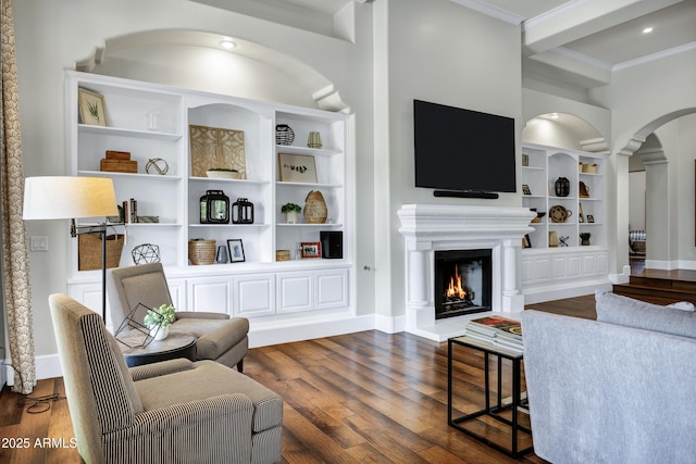2527 E Beechnut Ct, Chandler, AZ 85249 - living area featuring built in features, dark wood-type flooring, ornamental molding, arched walkways, and baseboards