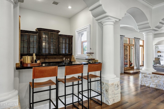 2527 E Beechnut Ct, Chandler, AZ 85249 - bar area featuring ornate columns, dark wood-type flooring, decorative backsplash, recessed lighting, and crown molding