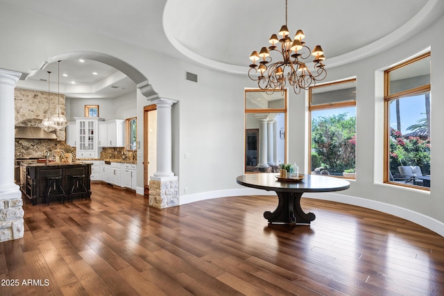 2527 E Beechnut Ct, Chandler, AZ 85249 - unfurnished dining area featuring a raised ceiling, a chandelier, dark wood-style flooring, decorative columns, and recessed lighting