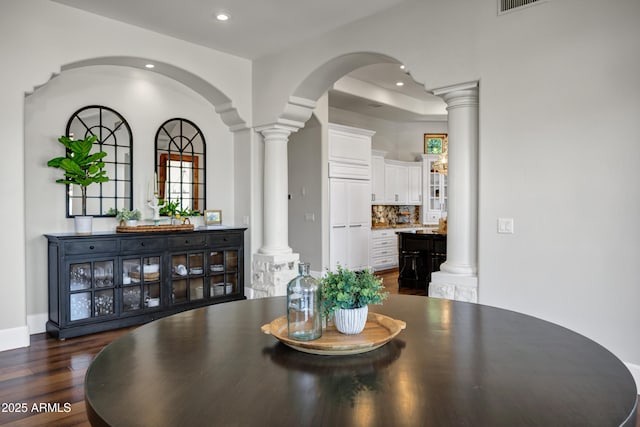 2527 E Beechnut Ct, Chandler, AZ 85249 - dining room featuring decorative columns, recessed lighting, arched walkways, and dark wood-style flooring