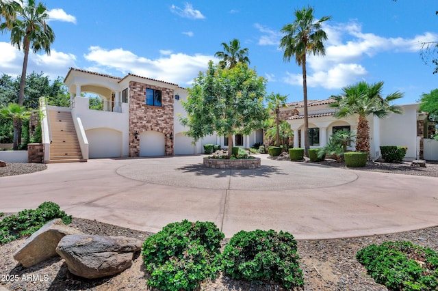 2527 E Beechnut Ct, Chandler, AZ 85249 - mediterranean / spanish home featuring stucco siding, stairs, curved driveway, an attached garage, and a tile roof