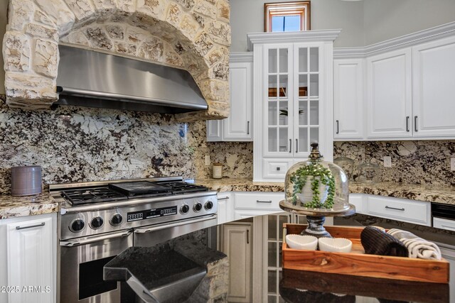 2527 E Beechnut Ct, Chandler, AZ 85249 - kitchen featuring range with two ovens, white cabinets, glass insert cabinets, and wall chimney range hood