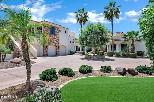 2527 E Beechnut Ct, Chandler, AZ 85249 - mediterranean / spanish-style home featuring stone siding, stucco siding, a tile roof, an attached garage, and curved driveway