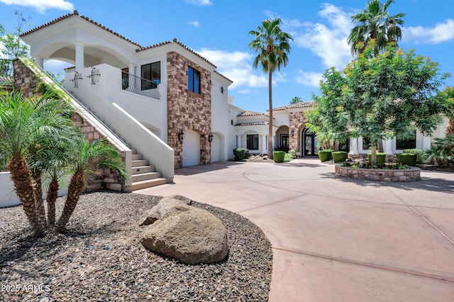2527 E Beechnut Ct, Chandler, AZ 85249 - mediterranean / spanish-style home with stucco siding, stone siding, curved driveway, a tiled roof, and stairway