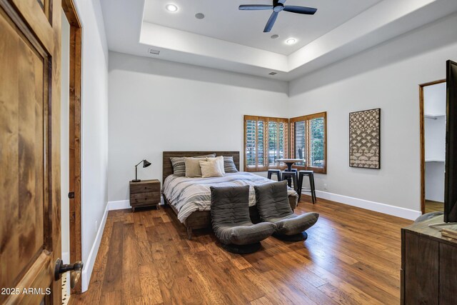 2527 E Beechnut Ct, Chandler, AZ 85249 - bedroom with baseboards, a tray ceiling, dark wood-type flooring, recessed lighting, and ceiling fan