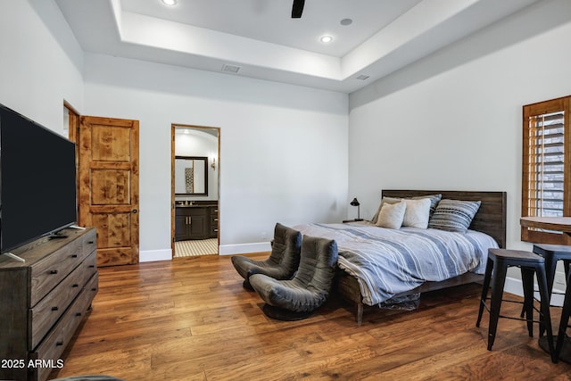2527 E Beechnut Ct, Chandler, AZ 85249 - bedroom featuring wood finished floors, a raised ceiling, baseboards, connected bathroom, and recessed lighting