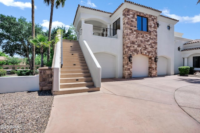 2527 E Beechnut Ct, Chandler, AZ 85249 - mediterranean / spanish-style home featuring an attached garage, stucco siding, stairs, and a tile roof