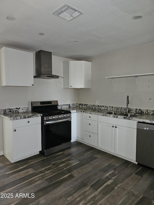 kitchen featuring sink, white cabinetry, stainless steel appliances, dark hardwood / wood-style floors, and wall chimney exhaust hood