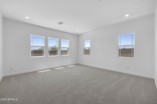 unfurnished room featuring carpet floors, baseboards, visible vents, and recessed lighting