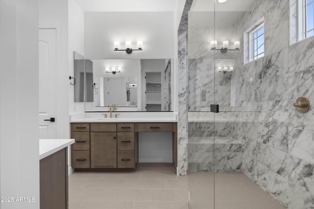 full bath with tile patterned flooring, a shower stall, and vanity