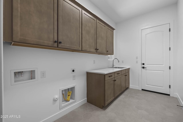 clothes washing area with hookup for a washing machine, hookup for an electric dryer, hookup for a gas dryer, a sink, and cabinet space