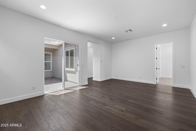 unfurnished room featuring dark wood-style floors, recessed lighting, visible vents, and baseboards