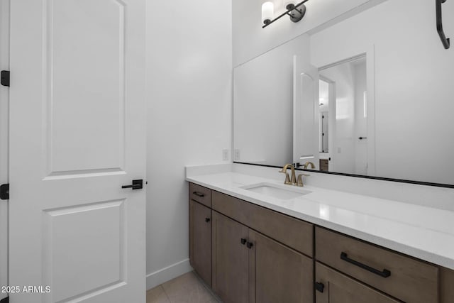 bathroom featuring tile patterned flooring, baseboards, and vanity