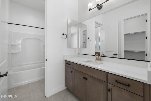 bathroom with  shower combination, tile patterned flooring, vanity, and baseboards