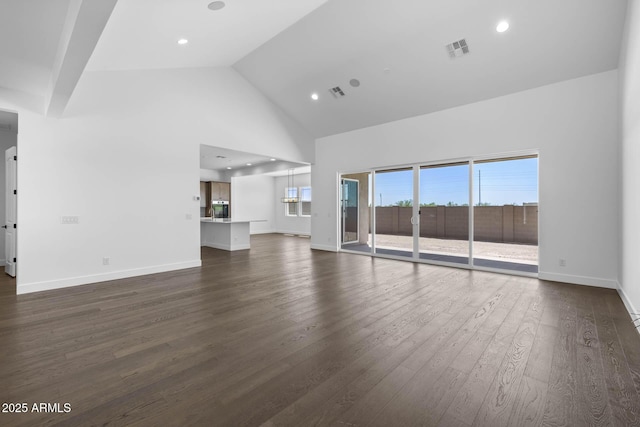 unfurnished living room featuring dark wood finished floors, recessed lighting, visible vents, high vaulted ceiling, and baseboards