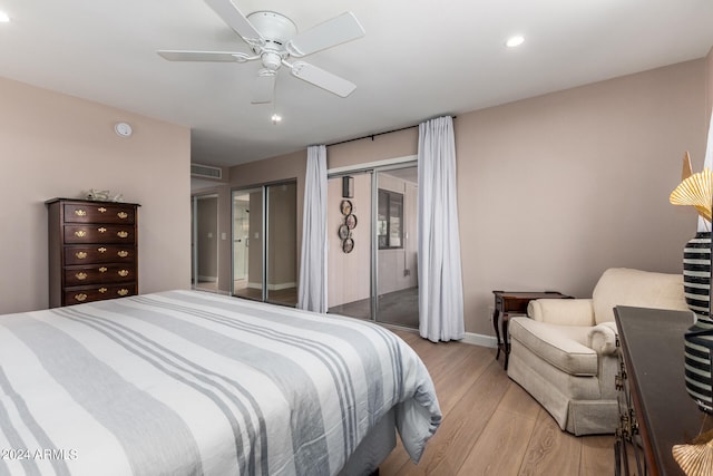 bedroom with light hardwood / wood-style floors and ceiling fan