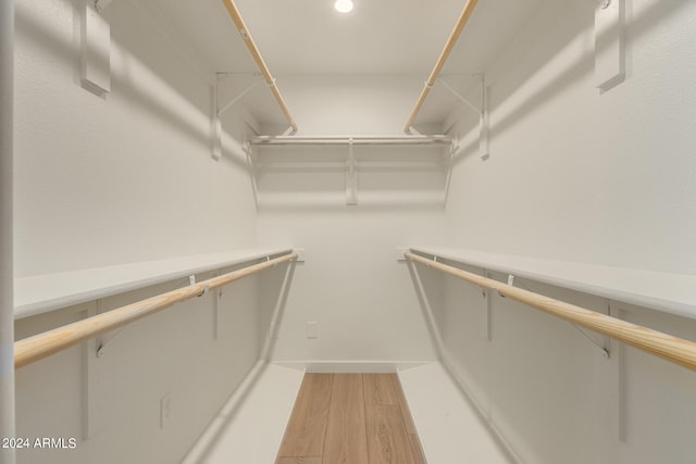 walk in closet featuring light hardwood / wood-style flooring