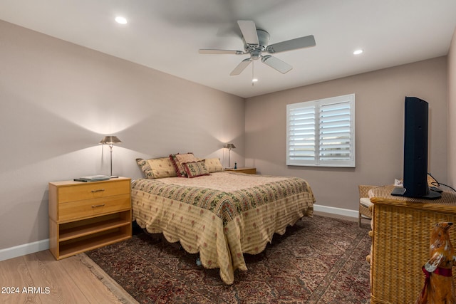 bedroom with ceiling fan and dark hardwood / wood-style floors