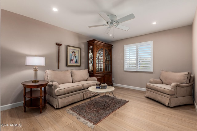 living room featuring ceiling fan and light wood-type flooring