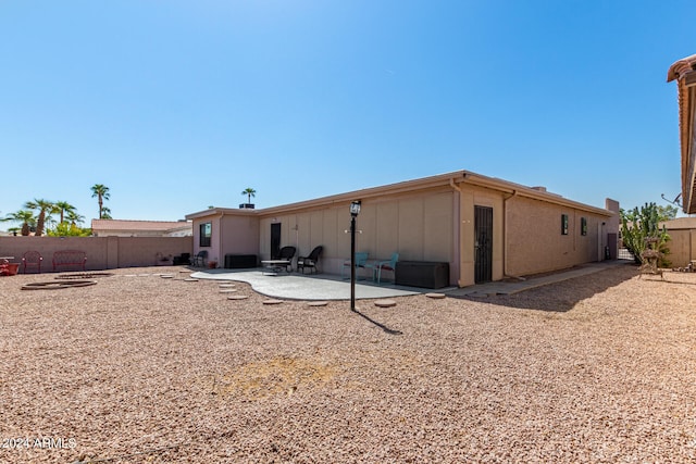 back of house with a patio