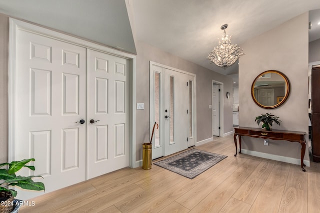 entrance foyer with a notable chandelier and light hardwood / wood-style floors