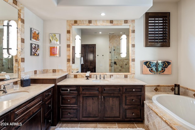 bathroom with vanity and shower with separate bathtub