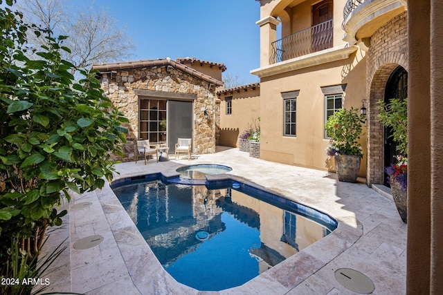 view of swimming pool featuring an in ground hot tub and a patio