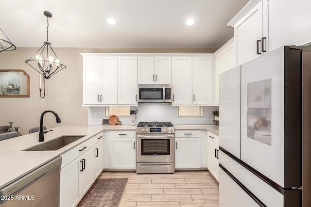 9624 E Thunderbolt Ave, Mesa, AZ 85212 - kitchen featuring appliances with stainless steel finishes, light countertops, backsplash, a chandelier, and white cabinetry