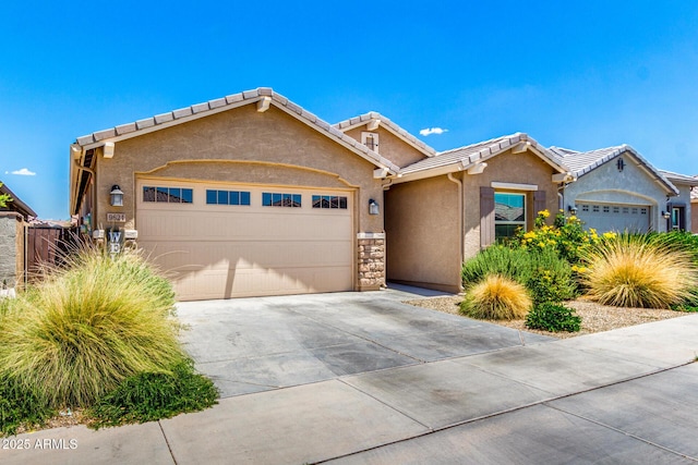 9624 E Thunderbolt Ave, Mesa, AZ 85212 - view of front of home with an attached garage, stucco siding, concrete driveway, a tile roof, and stone siding