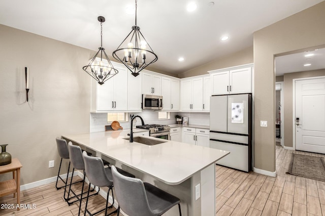 9624 E Thunderbolt Ave, Mesa, AZ 85212 - kitchen with stainless steel appliances, light countertops, backsplash, a peninsula, and light wood-style floors