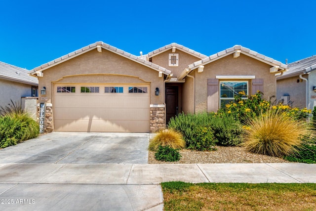 9624 E Thunderbolt Ave, Mesa, AZ 85212 - view of front facade featuring a garage, stucco siding, concrete driveway, stone siding, and a tile roof