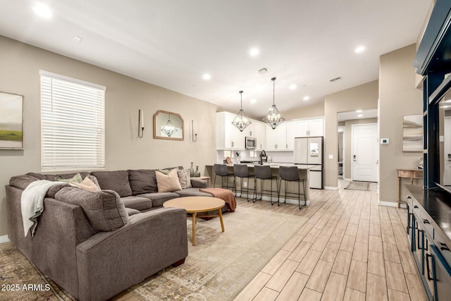 9624 E Thunderbolt Ave, Mesa, AZ 85212 - living room featuring light wood-style floors, recessed lighting, a chandelier, and lofted ceiling