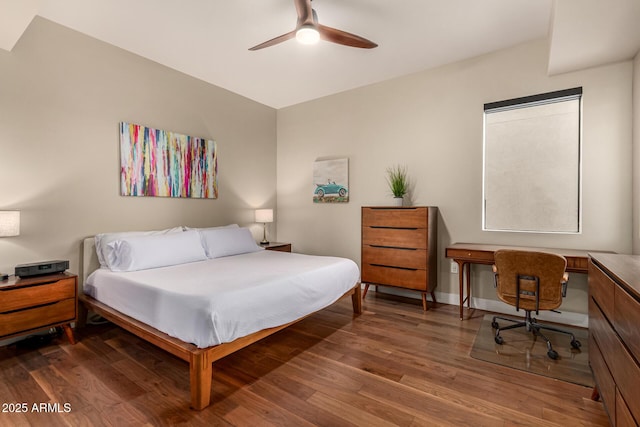3131 N Central Ave Unit 3004, Phoenix, AZ 85012 - bedroom with wood finished floors, a desk, and a ceiling fan