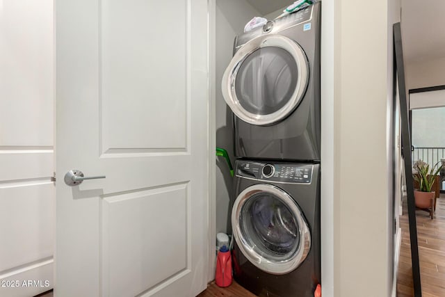 3131 N Central Ave Unit 3004, Phoenix, AZ 85012 - laundry room featuring stacked washer / dryer and wood finished floors