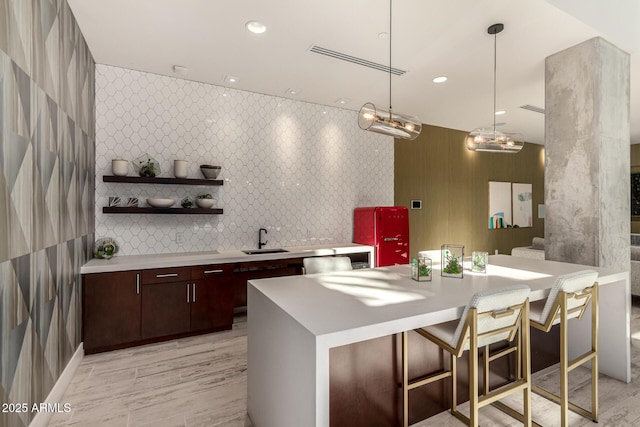 3131 N Central Ave Unit 3004, Phoenix, AZ 85012 - kitchen featuring light countertops, open shelves, dark brown cabinetry, a kitchen bar, and recessed lighting