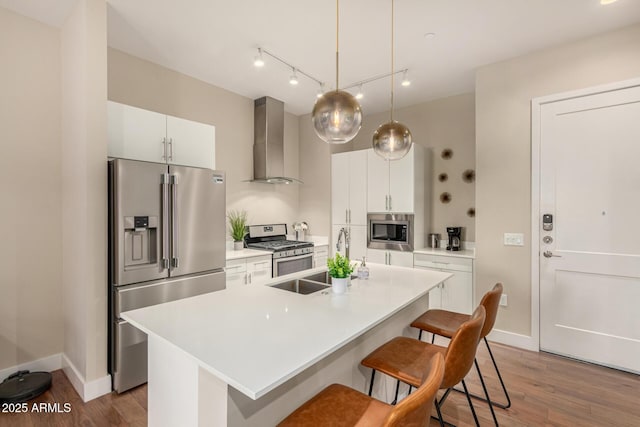 3131 N Central Ave Unit 3004, Phoenix, AZ 85012 - kitchen with wall chimney exhaust hood, appliances with stainless steel finishes, wood finished floors, a breakfast bar, and an island with sink