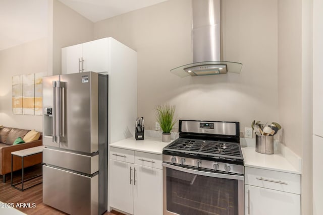 3131 N Central Ave Unit 3004, Phoenix, AZ 85012 - kitchen featuring appliances with stainless steel finishes, wall chimney range hood, light countertops, white cabinets, and wood finished floors