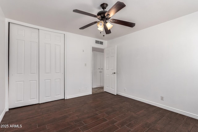 3644 W Maryland Ave, Phoenix, AZ 85019 - unfurnished bedroom featuring dark wood-style flooring, baseboards, and a closet