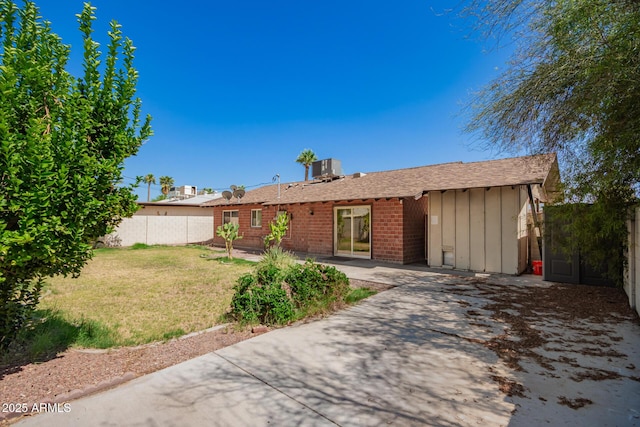 3644 W Maryland Ave, Phoenix, AZ 85019 - ranch-style home featuring board and batten siding, a patio area, brick siding, central AC, and a shingled roof