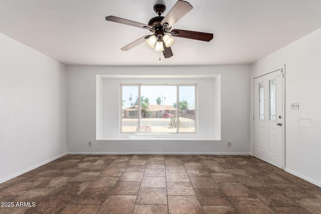 3644 W Maryland Ave, Phoenix, AZ 85019 - foyer entrance with plenty of natural light, baseboards, stone finish flooring, and a ceiling fan